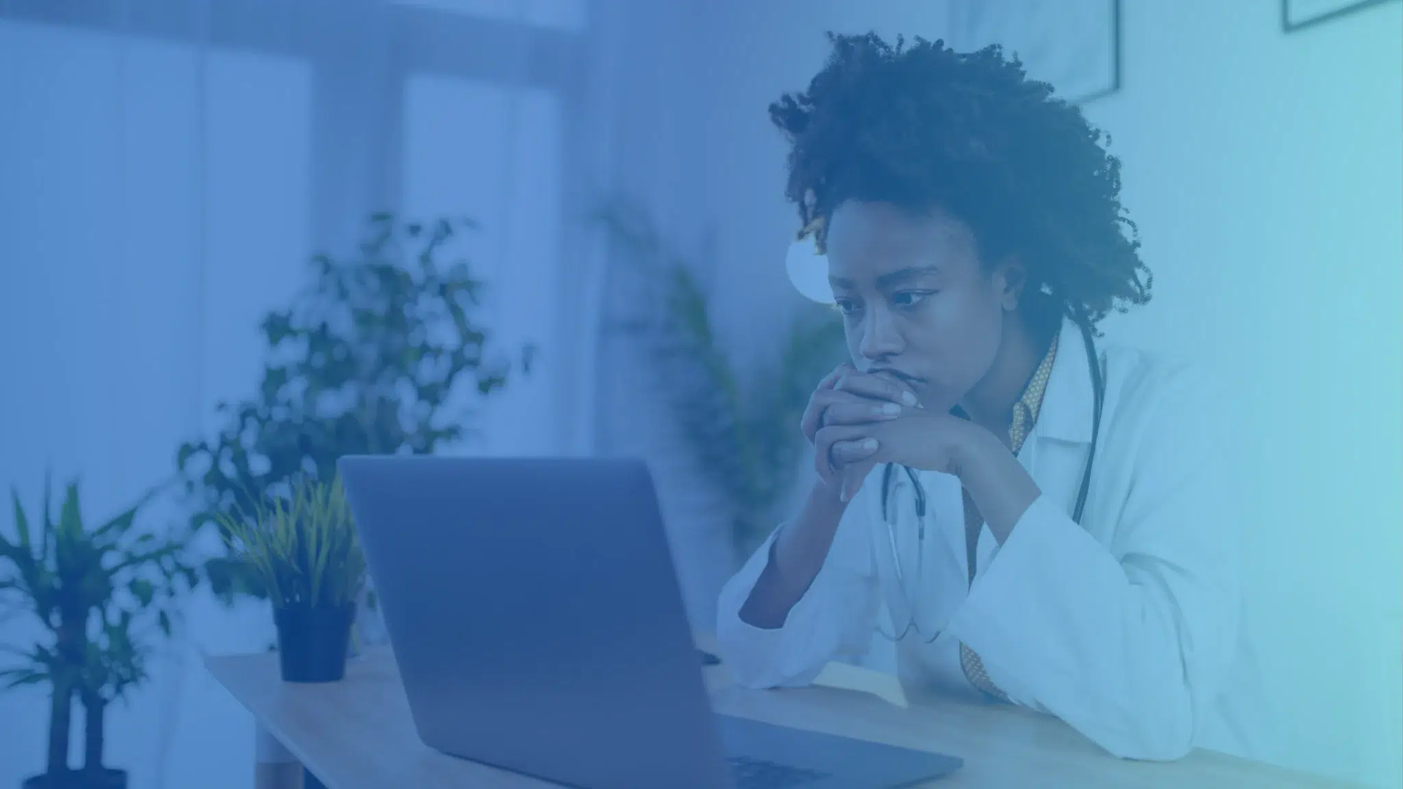 worried doctor in front of computer
