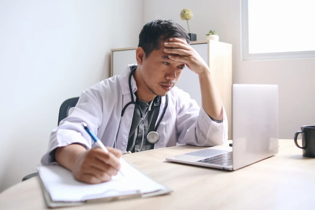 upset depressed doctor asian male